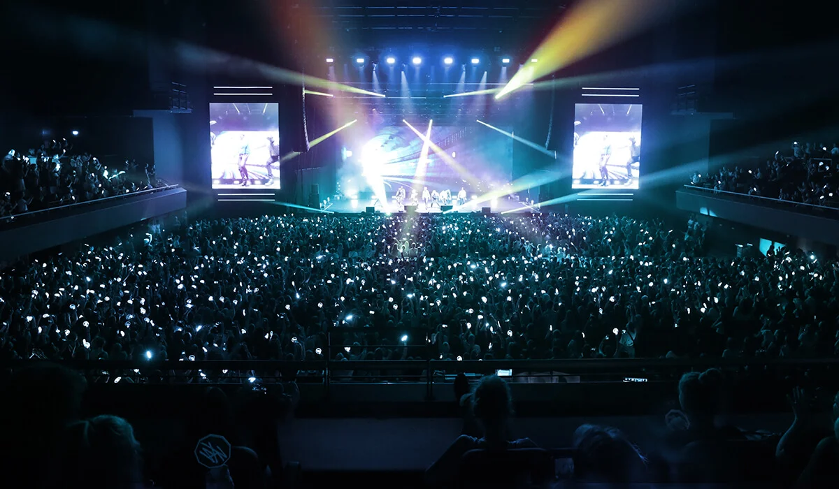 Arena view from the upper deck during a concert with stage lighting